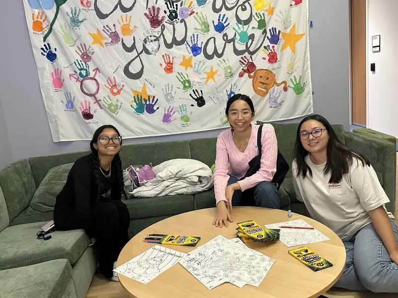 Three students sitting in the Wellness Spot in the Francine LeFrak Center