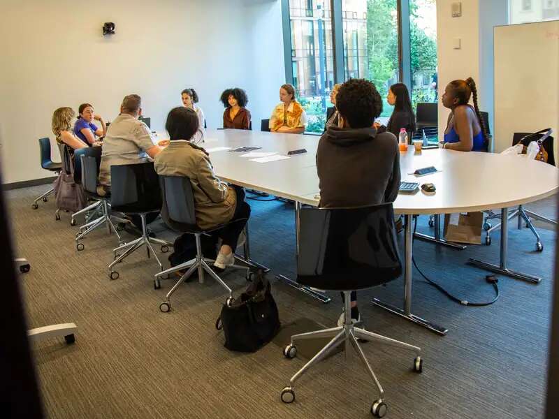 Students seated around a summer table in summer