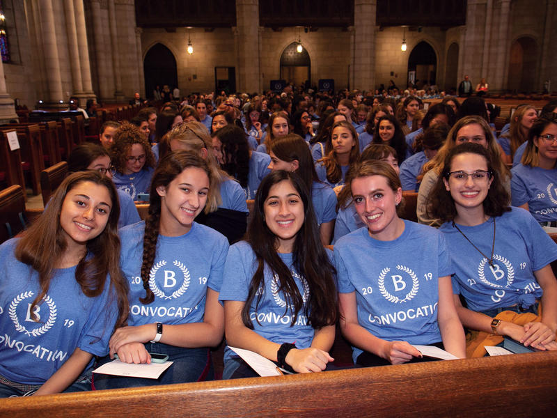 First-year students assembled in Riverside Church wearing matching convocation t-shirts