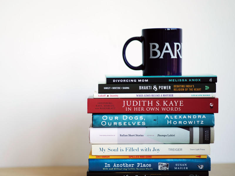short stack of books with a coffee mug on top