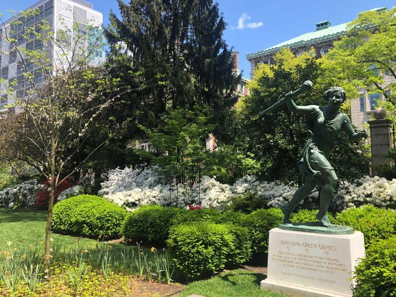 Barnard's green campus and the running woman statue
