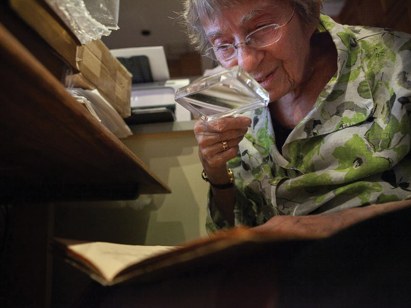 Madeline Kripke peering at a dictionary