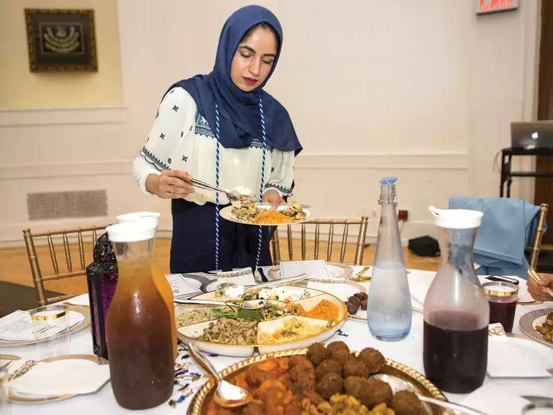 Camilla Cerea placing food on a plate at a dinner table