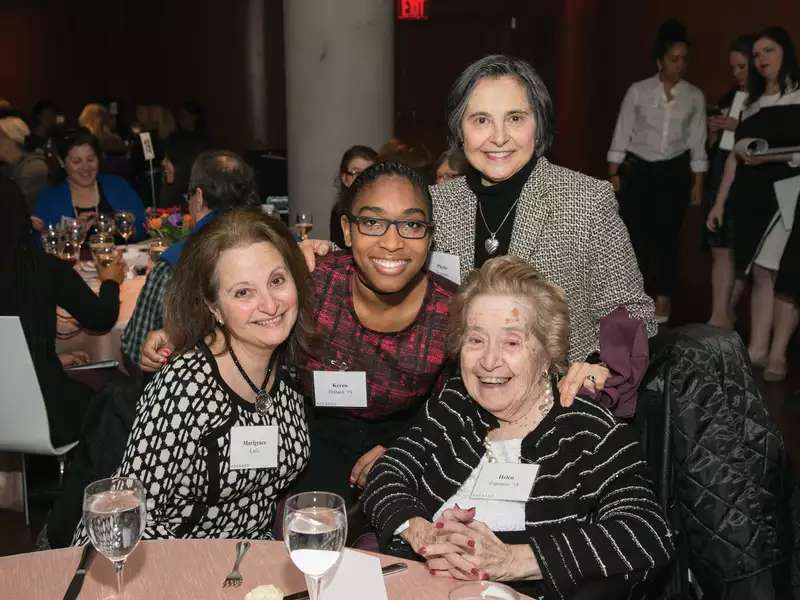 4 women posed together, lookng at the camera