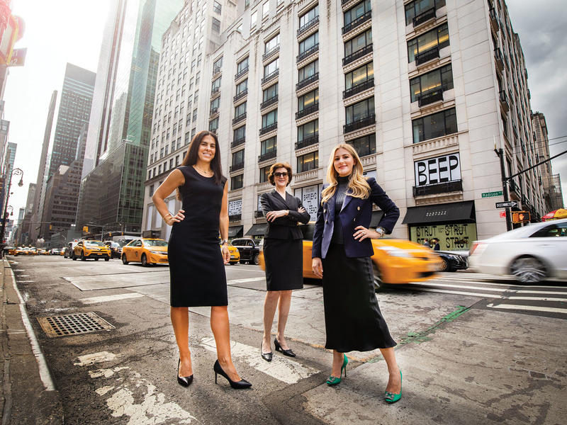 3 women in black on a New York City street