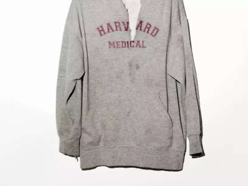 a worn, gray Harvard sweatshirt