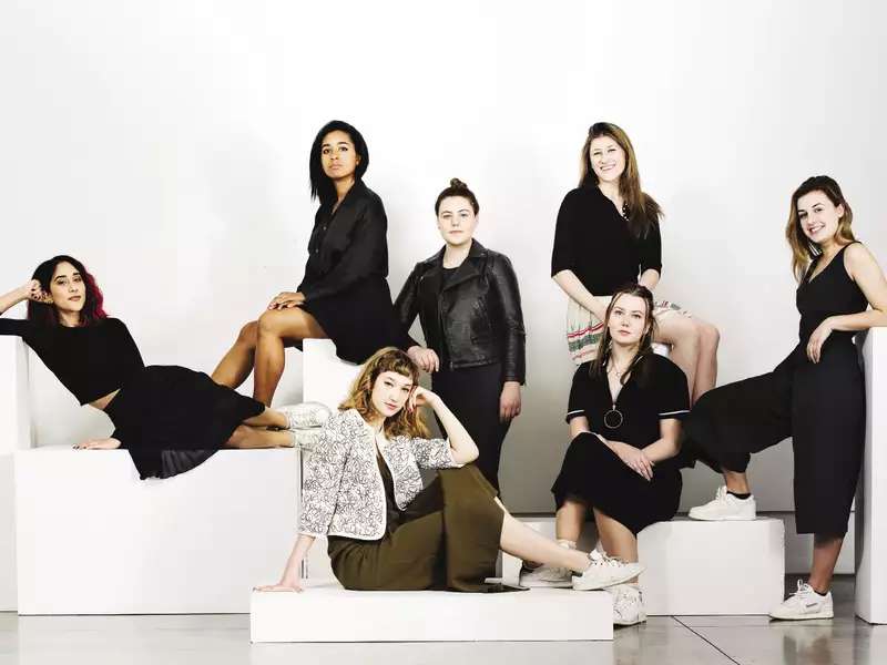 6 women in black in a formal portrait