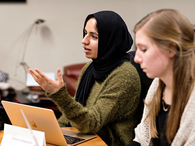 A student in a hijab speaks up during class